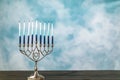 A silver menorah for the Jewish holiday Hanukkah with eight unlit candles