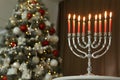 Silver menorah in room with Christmas tree  space for text Royalty Free Stock Photo