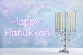 Silver menorah on white table. Happy Hanukkah