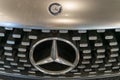 Silver Mercedes car. Bumper and headlights. Logo emblem on the hood. Warsaw, Poland - 28.07.2023.