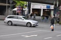 Silver Mercedes E-Class (S 212) facelift while driving on intersection in Bochum, Germany.