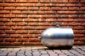 a silver metal cylinder of propane gas on a brick wall Royalty Free Stock Photo