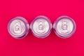 Silver metal energy drinks cans on pink background Royalty Free Stock Photo