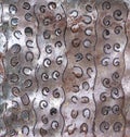 Aluminum metal panel with cutout squiggle designs and rust background texture