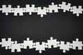 Silver metal puzzle pieces arranged as a frame on black color background with copy space, business partnership concept Royalty Free Stock Photo