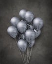 Silver metallic air balloons group on a concrete background