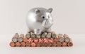 Silver Metallic Piggy Bank and Wrapped Coins Royalty Free Stock Photo