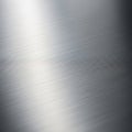 Silver metallic surface with a fine, brushed texture, featuring horizontal lines running across. Royalty Free Stock Photo