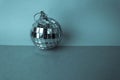 Silver mirror musical club disco ball xmas festive Christmas ball, Christmas toy plastered on sparkles on a blue background Royalty Free Stock Photo