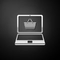 Silver Mobile phone and shopping basket icon isolated on black background. Online buying symbol. Supermarket basket