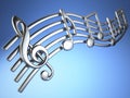 Silver music notes and treble clef on musical strings on blue ba Royalty Free Stock Photo