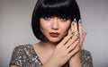 Silver nail art polish manicure. Short bob hair woman model. Fashion brunette close up portrait with beauty makeup and glossy man Royalty Free Stock Photo