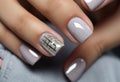 silver nail manicure with metallics in womens hands.