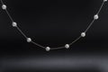 Silver necklace chain with pearls  on black Royalty Free Stock Photo