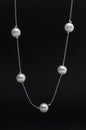 Silver necklace chain with pearls  on black Royalty Free Stock Photo