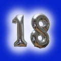 Silver number 18 party balloons isolated on a blue background