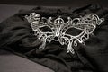 Silver organdy mask on a black cloth Royalty Free Stock Photo