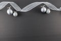 Silver Ornaments and Ribbon on Black Slate Background Royalty Free Stock Photo