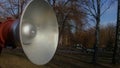 Silver painted loudspeaker on blurry trees background Royalty Free Stock Photo