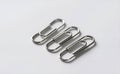 Silver paper clips arranged in pattern, perfect for small office essentials. Royalty Free Stock Photo