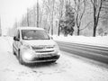 Silver passenger van Opel Combo Life on the road during a snowfall.