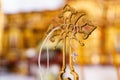 A silver pectoral cross on a string on a large gold cross of the baptismal font.