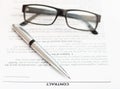 Silver pen and eyeglasses on sales contract Royalty Free Stock Photo