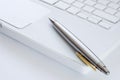 Silver pen on a laptop keyboard Royalty Free Stock Photo