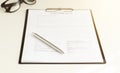 document pad while female hands working on notebook pc in background. Office life, paperwork, client contract Royalty Free Stock Photo