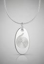 Silver pendant with an oval shape and a spiral design in the center. The pendant hangs from a Royalty Free Stock Photo