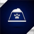 Silver Pet food bowl for cat or dog icon isolated on dark blue background. Dog or cat paw print. Vector Royalty Free Stock Photo