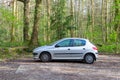 A 2001 silver Peugeot 206 in the woods Royalty Free Stock Photo