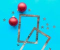 Silver photo frame and Christmas baubles on bright blue background. Royalty Free Stock Photo