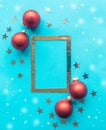 Silver photo frame decorative with stars and red baubles on bright blue background. Royalty Free Stock Photo