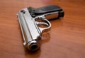 Silver pistol on a table Royalty Free Stock Photo