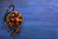 Silver plate with dates and  tasbih misbaha on old  dark blue wooden table. Ramadan background. Flat lay.  Selective focus Royalty Free Stock Photo