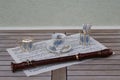 English teacup and saucer, spoon vase, teaspoon and cream jug and a block flute on a sheet of music