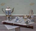 English tea set, metronome for music and a block flute on a sheet of music Royalty Free Stock Photo