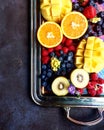 Silver Platter with mix of cut exotic citrus fruits like oranges, mango, kiwi and berries top view Royalty Free Stock Photo