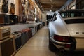 Silver Porsche 911 at Walt Grace with guitars in the background.