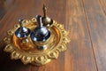 Silver pour water containers on golden tray