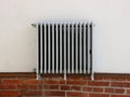 Silver Radiator Mounted on White Wall