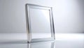 Silver Rectangular Frame Standing on Shiny White Surface with Soft Lighting Royalty Free Stock Photo