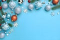 Silver and red baubles and snowflakes, spruce branches on blue background. Top view.Christmas bright background, banner with space Royalty Free Stock Photo