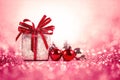 Silver and red Christmas balls and gifts on sweet red pink glitter lighting background Royalty Free Stock Photo