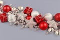 Silver and Red Christmas ornaments like small gift boxes, round baubles, bells and stars Royalty Free Stock Photo
