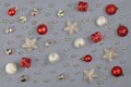 Silver and red Christmas ornaments like small gift boxes, round baubles, bells and stars Royalty Free Stock Photo