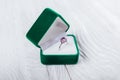 Silver ring with amethyst in green gift box on white background. Present for Valentines day