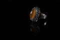 Silver ring with cornelian on a black background Royalty Free Stock Photo