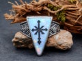 A silver ring with a cross design on a rock. Royalty Free Stock Photo